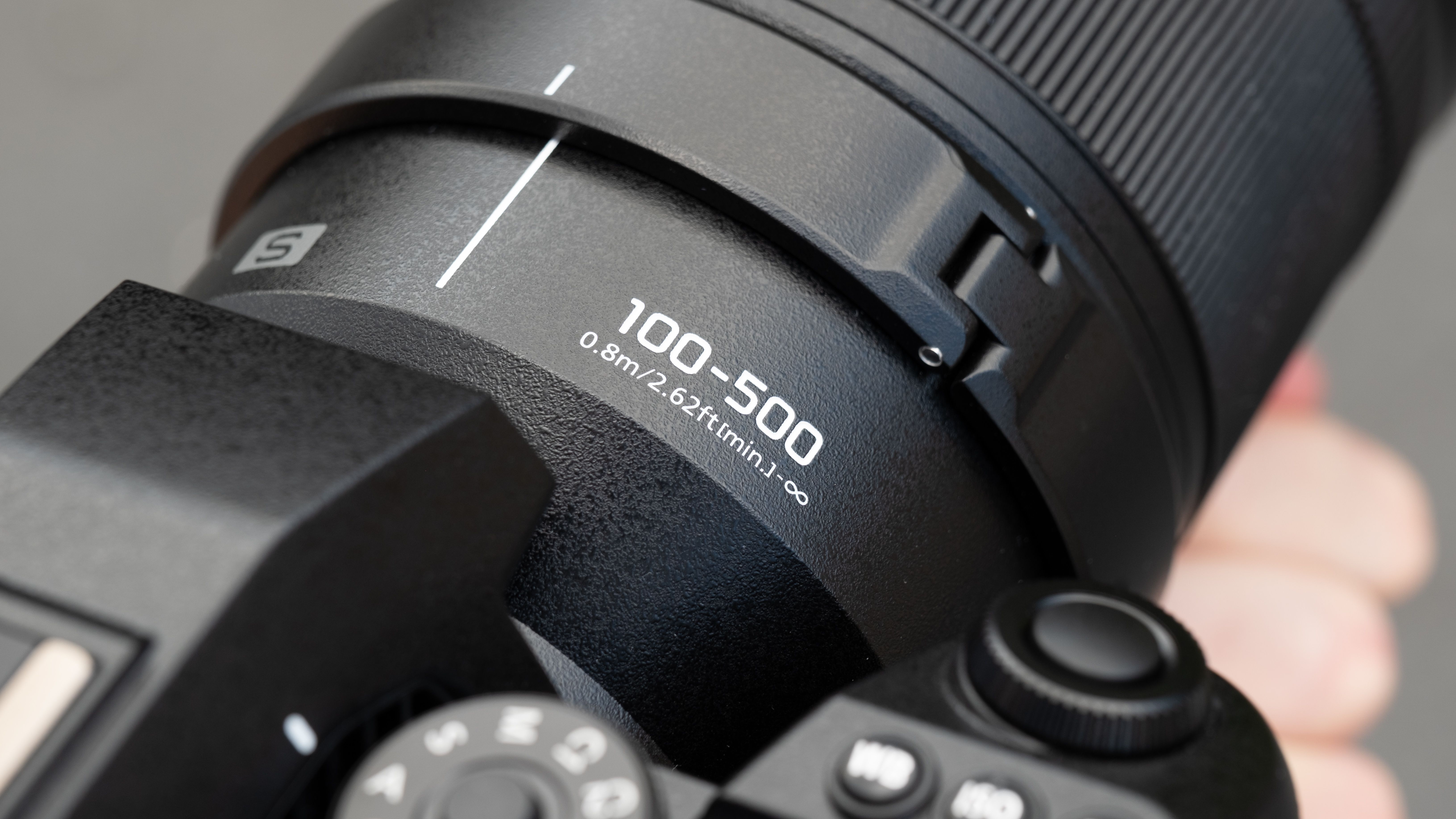 Close up of text reading 100-500 on a Lumix S 100-500mm f/5-7.1 lens