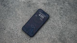 The iPhone 14 Pro placed on a concrete surface.