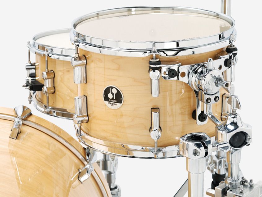 Vibration-free Total Acoustic Resonance bracket is attached to two of the small tom's tension rods and anchored to the shell