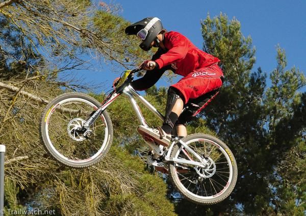 Catching air on a perfect morning for bike racing
