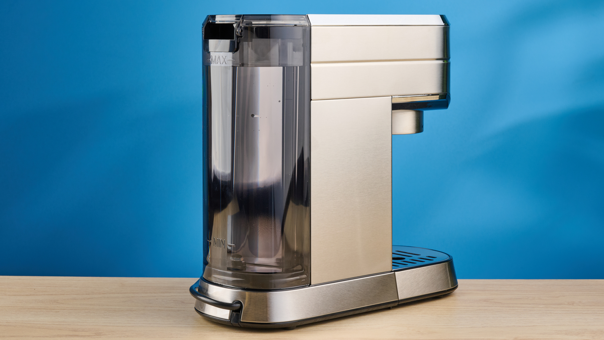 the casabrews cm5418 espresso machine in silver showing its steam wand and water tank and accessories