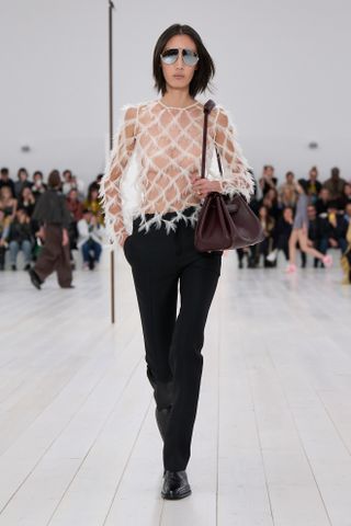 Woman in slim-fitting pants on the Loewe runway