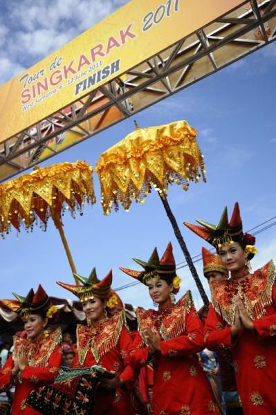 Women wearing Indonesian traditional dress take part in the opening ceremony