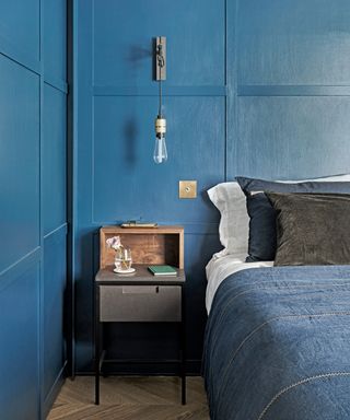 A teenage boys bedroom idea with gloss blue painted wall panels and denim bedding