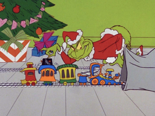 Best animated movies of the 1960s; a green creature dressed as Santa Claus steals a train set