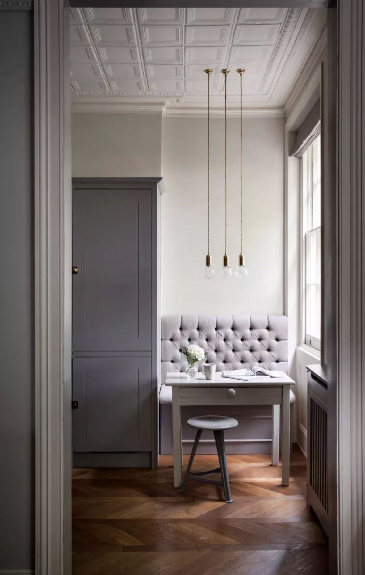 Grey kitchen with built in upholstered bench