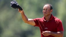 Tiger Woods take his cap off to acknowledge fans at the 2024 Masters