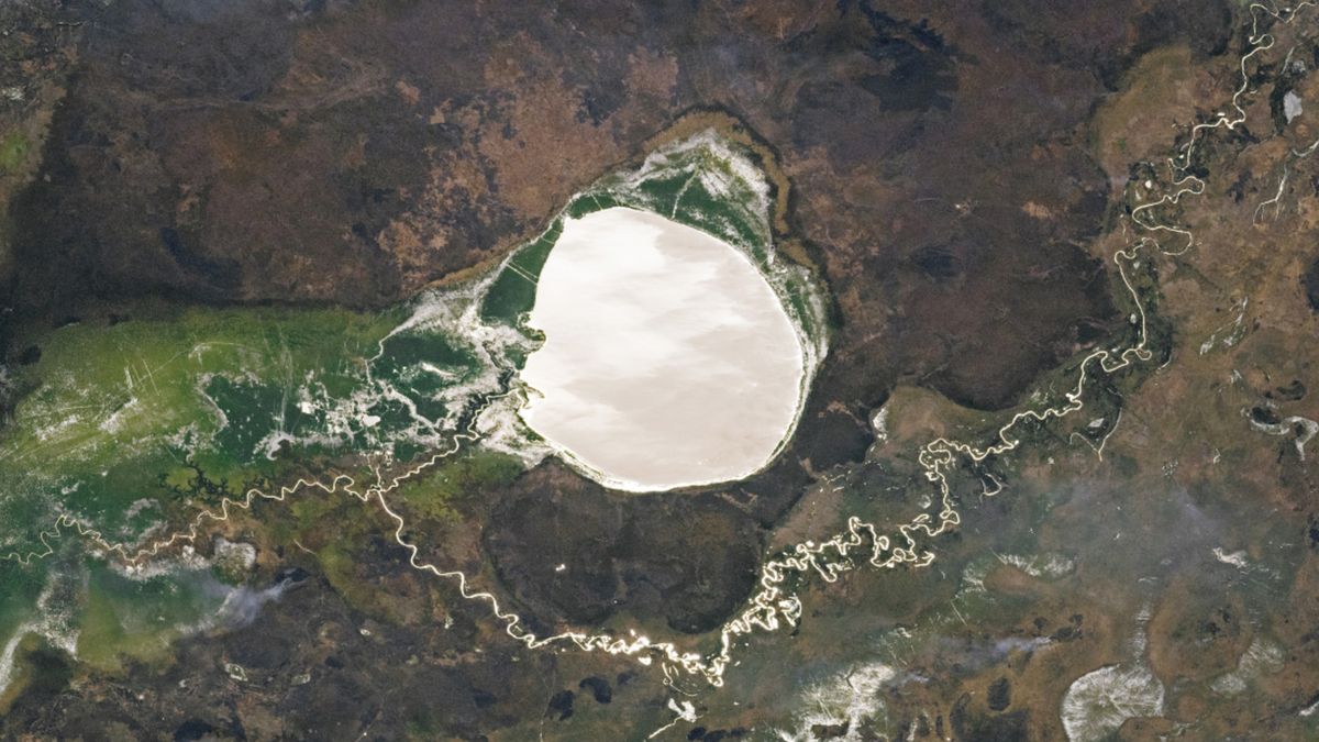 Lake-filled impact crater in Africa transforms into a giant silver ...
