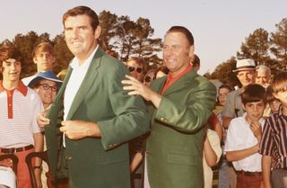 Billy Casper (right) helps Masters Champion Charles Coody with his Green Jacket at the Presentation Ceremony during the 1971 Masters Tournament