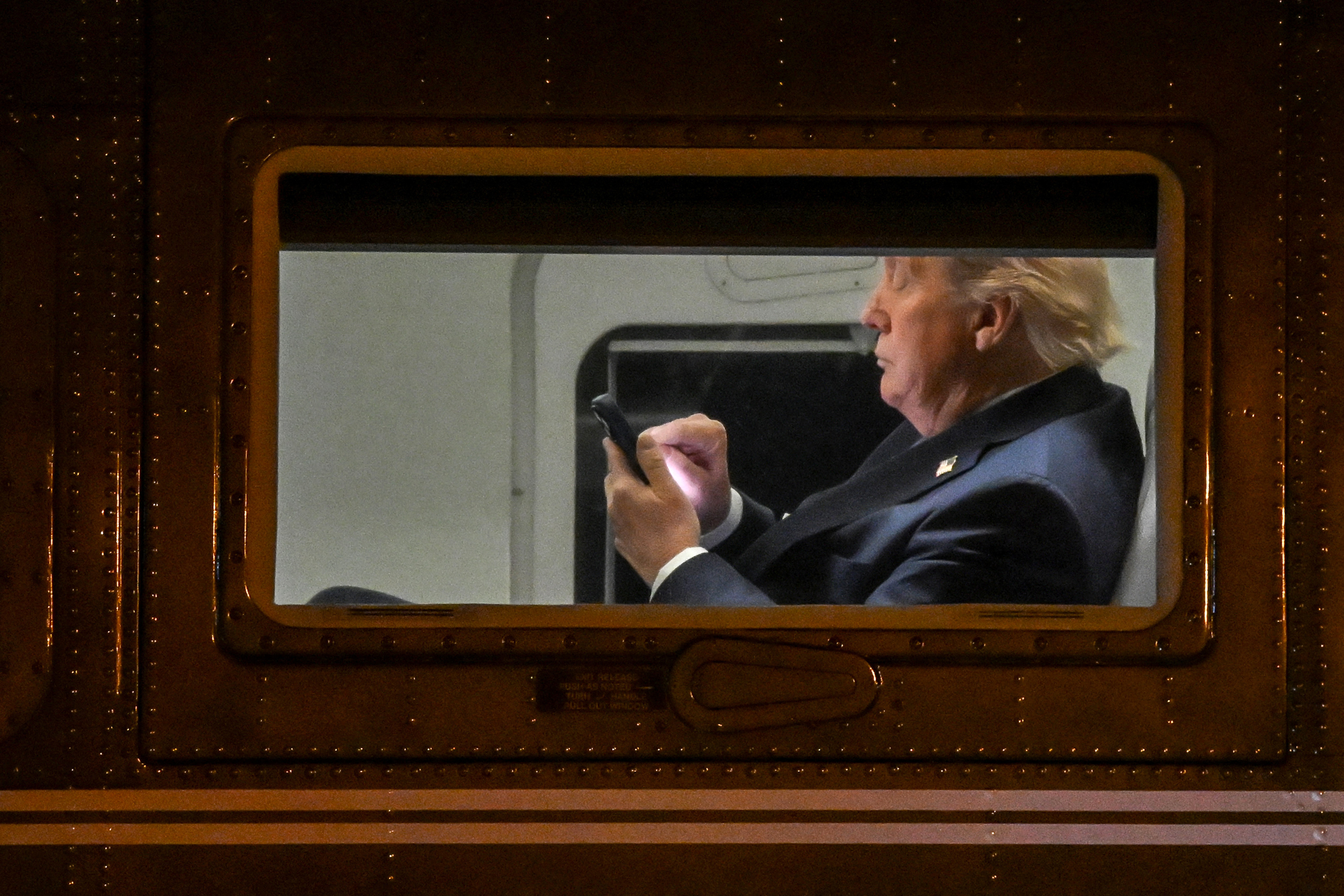 Trump looking at his phone