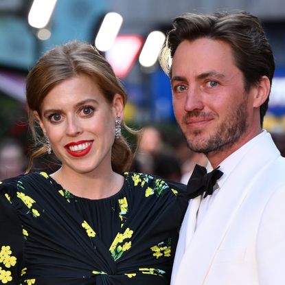 Princess Beatrice wears a black dress featuring yellow flowers and has red lipstick on, while her husband Edoardo Mapelli Mozzi wears a white tuxedo