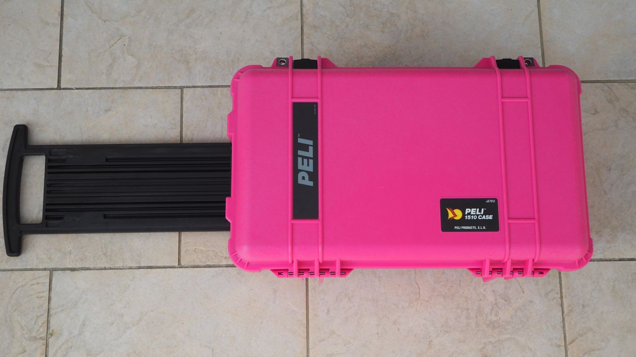 Peli / Pelican 1510 protector case in bright pink on a flagstone floor