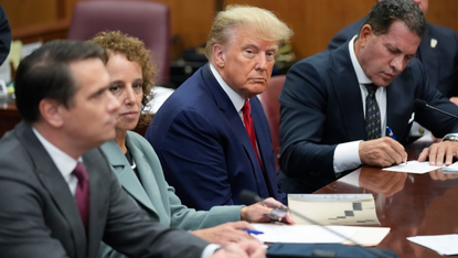 Donald Trump sits with his lawyers during his arraignment on 4 April 2023