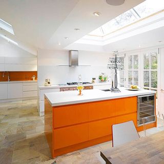 white kitchen with orange worktop