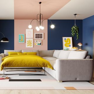 A pink and blue living room with a grey sofa bed with yellow bedding