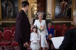 Bride Grace with Lexi Roscoe carrying the wedding ring in Hollyoaks.