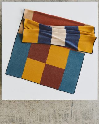 An Hermès blanket on concrete floor