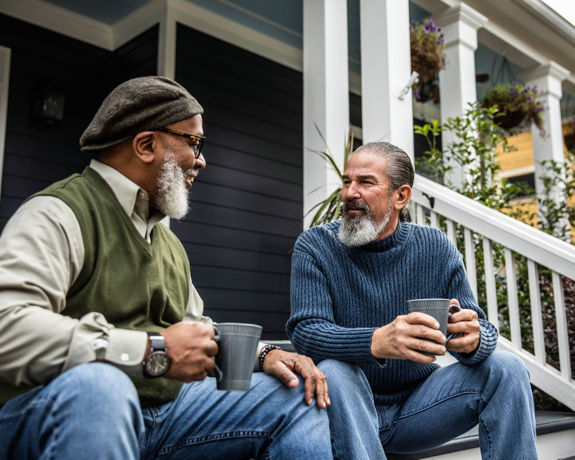 Two senior male neighbors talking over coffee