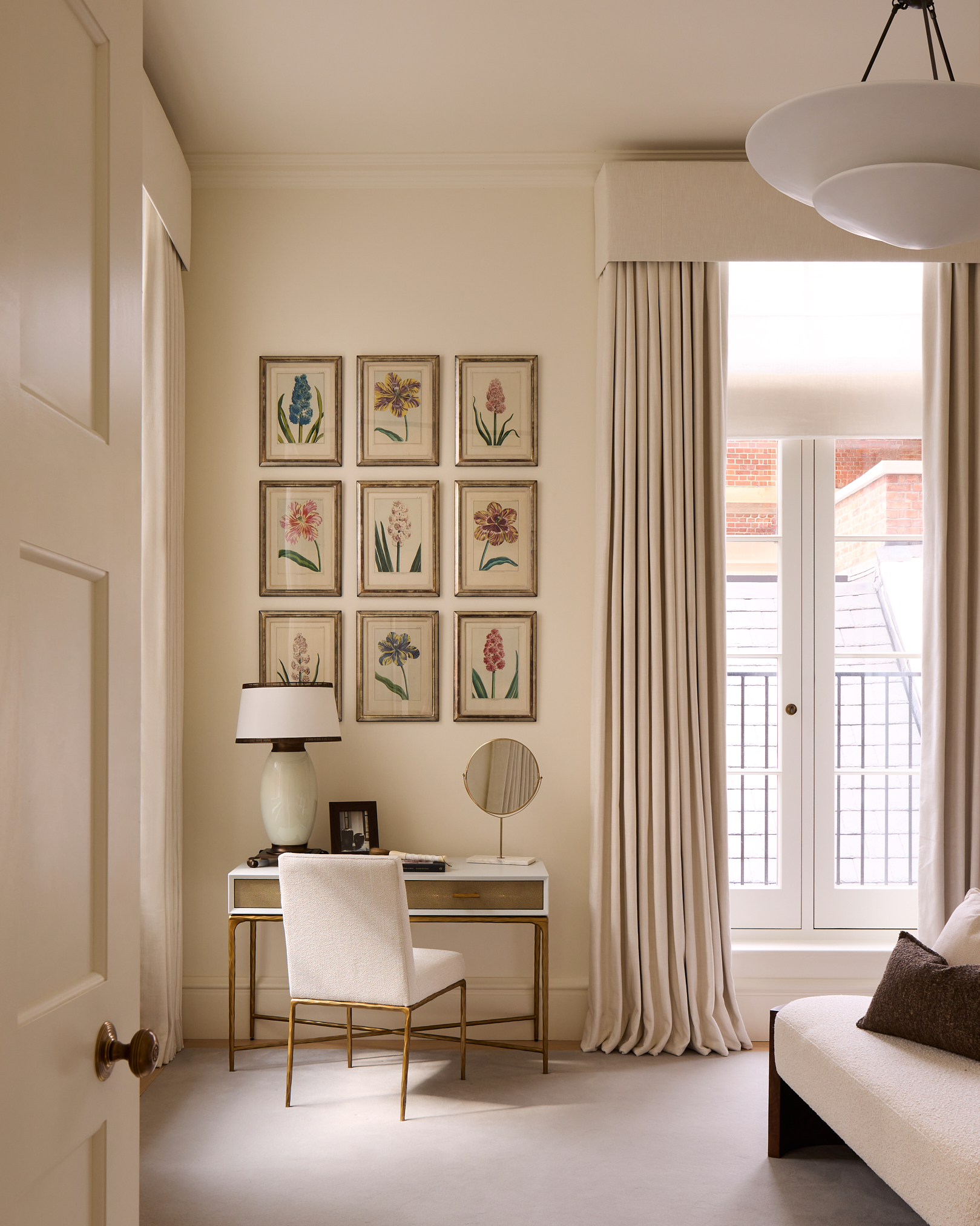 A set of botanical prints introduce colour to the otherwise neutral principal bedroom of the first-floor apartment