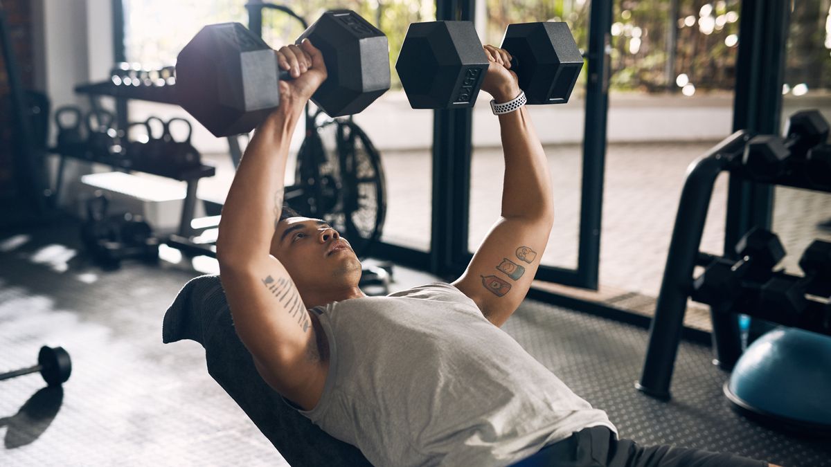 Man performs incline dumbbell bench press