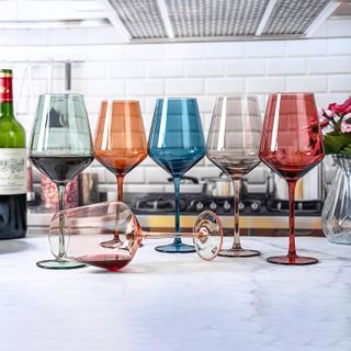 six wine glasses tinted with different colors