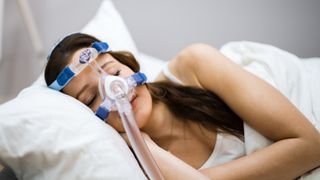 Woman wearing sleep apnea mask