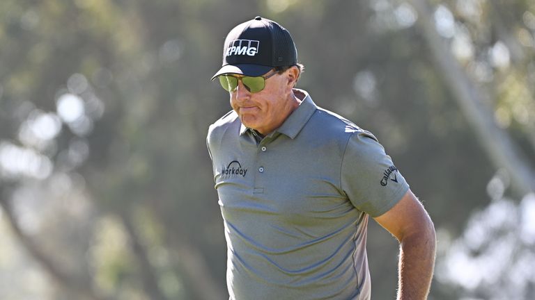 Phil Mickelson walks to the hole after putt