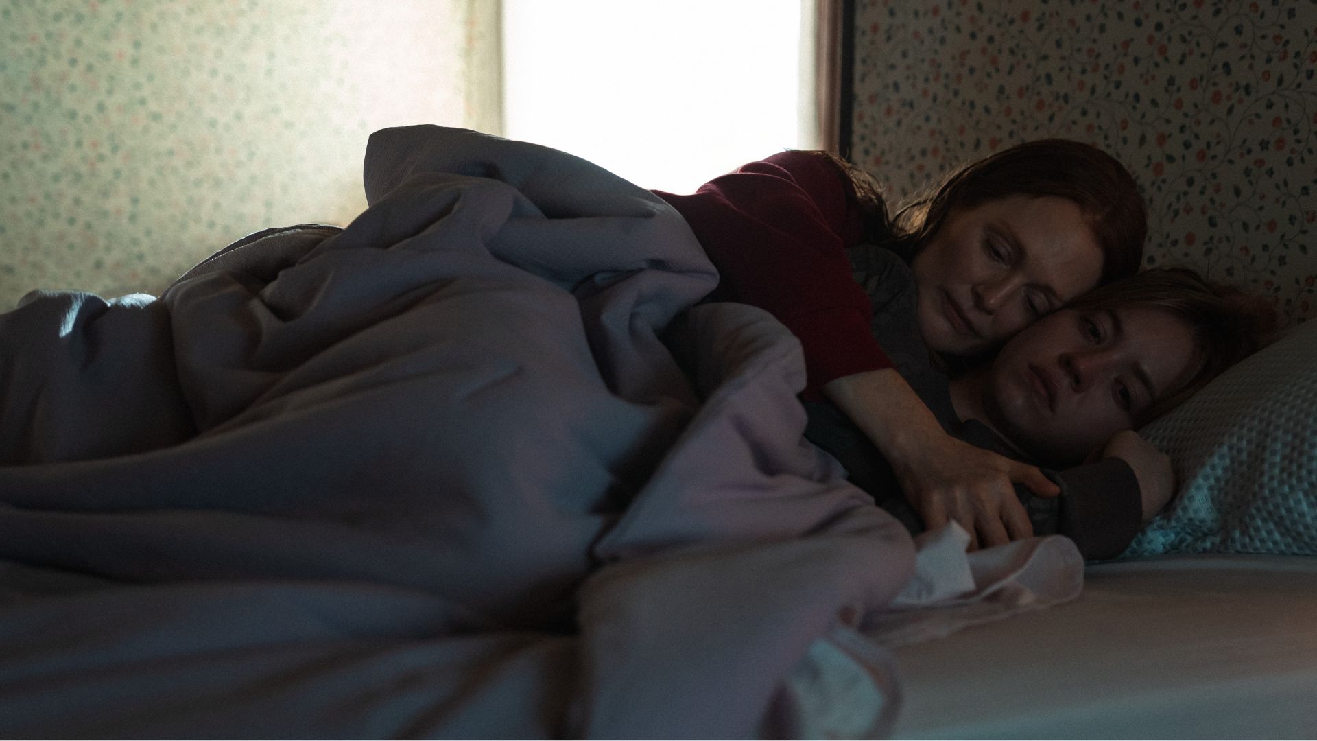 An image of Julianne Moore and Sydney Sweeney in "Echo Valley." They are both lying in bed in Sweeney's childhood bedroom