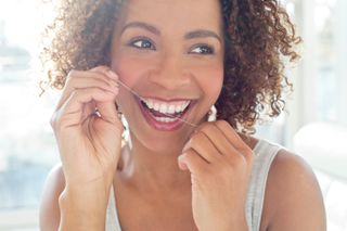 Get-glued-up-on-your-dental-health woman using dental floss