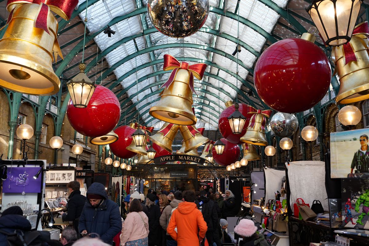 Christmas decorations up above an art market in Covent Garden