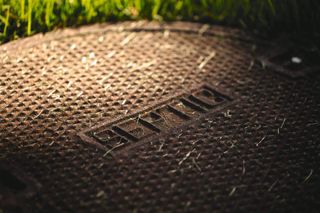 A septic tank lid surrounded by grass