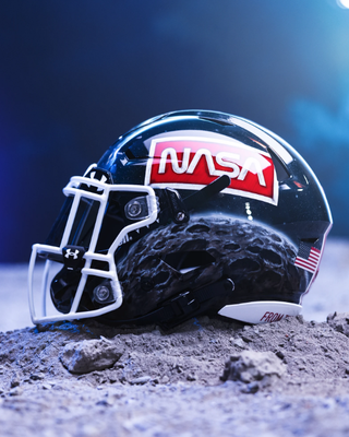 a black football helmet sporting the nasa worm logo and an image of the moon
