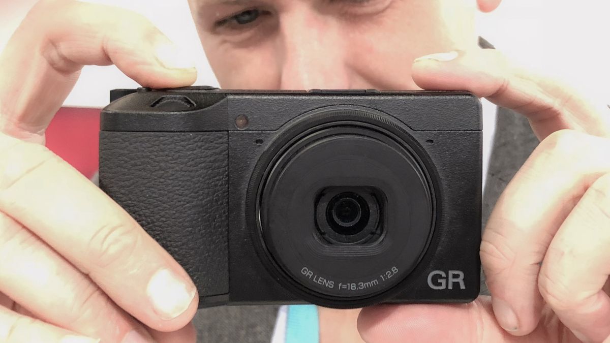 Ricoh GR III being held in a man&#039;s hands