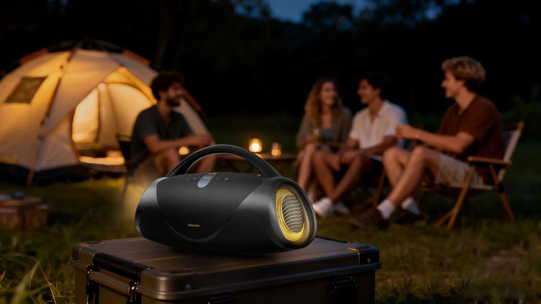 Hisense VoyageBoom Bluetooth speaker outside in front of some tenters