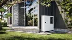 Heat pump installed at the wall of a modern single-family house