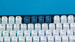 the keychron q12 max southpaw keyboard in navy blue with white and teal keycaps and red jupiter gateron switches