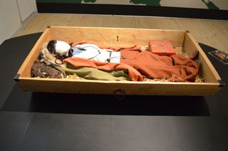 One of three people found in the tomb was a wealthy Viking woman, who was buried in a wooden cart similar to this reconstruction at Silkeborg Museum.