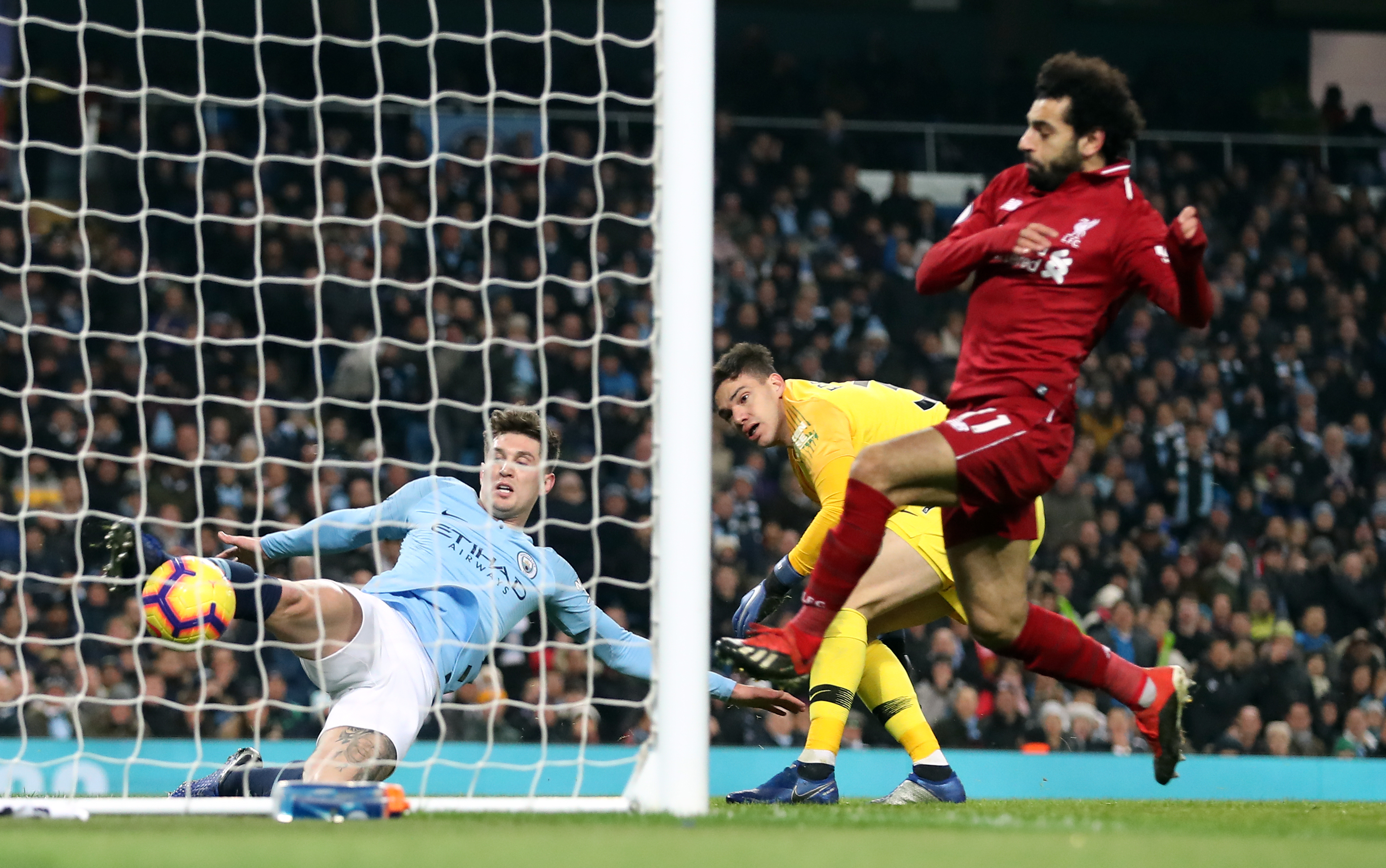 Manchester City’s John Stones (left) clears the ball (PA)