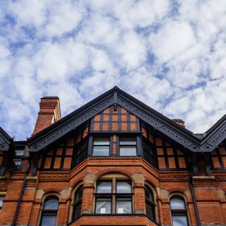 city with brick wall and cloudy sky