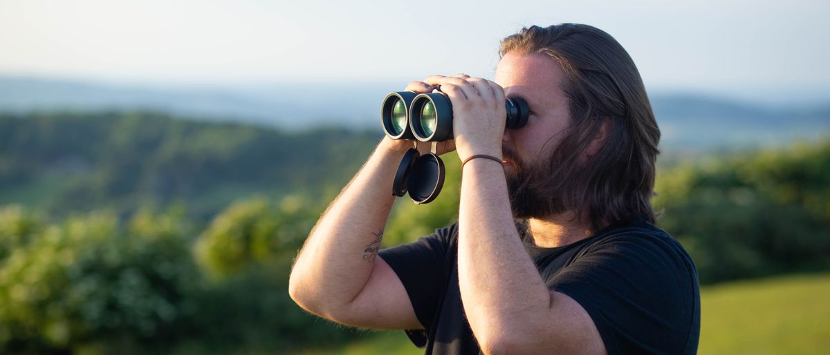 Jason Parnell-Brookes looking into the distance using the Celestron Nature DX 12x56 binoculars