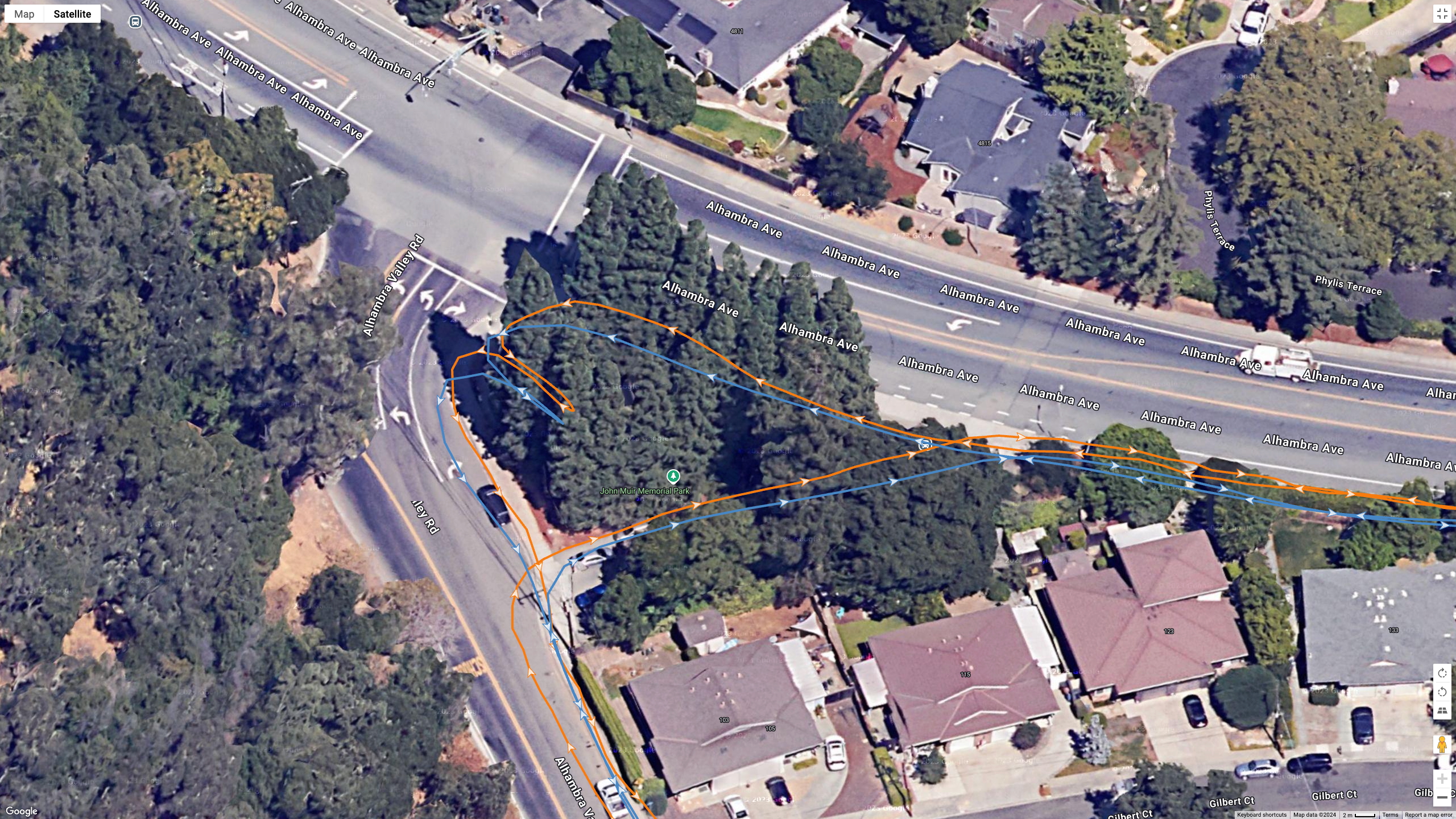 A Google Earth satellite image showing GPS lines for the COROS PACE Pro (blue) and Garmin Fenix 8 (orange) to test their dual-band GPS accuracy.