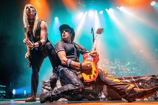 Nita Strauss (left) and Ryan Roxie perform onstage with Alice Cooper