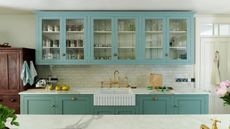 pale blue kitchen cabinets and white tiles