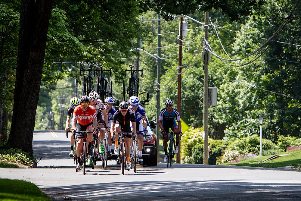 The break rolls through a neighborhood alongtheu course