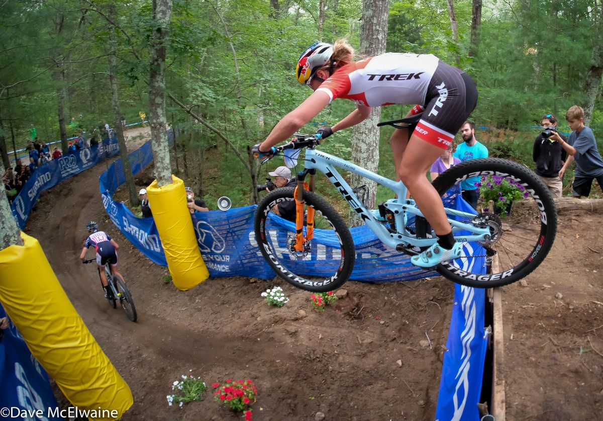 Canadian Champion Emily Batty chasing Courtney at the end of lap one