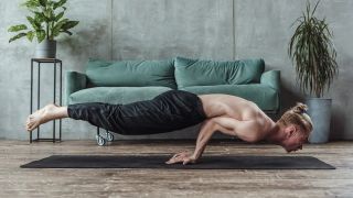 Man performs elbow planche balance