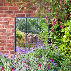 garden with window on red brick wall