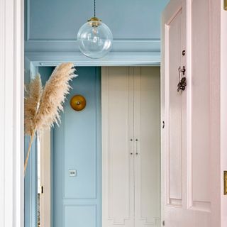 Blue, white, and pink doorway leading into hallway
