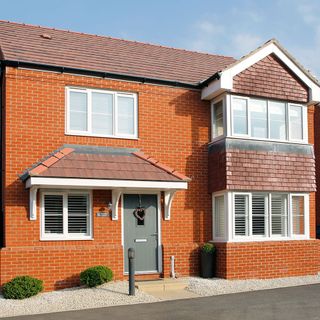 home with brick wall and white window