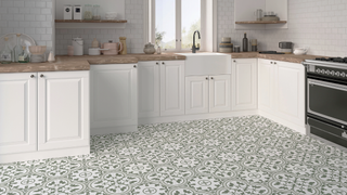 Kitchen with patterned flooring and white cabinets